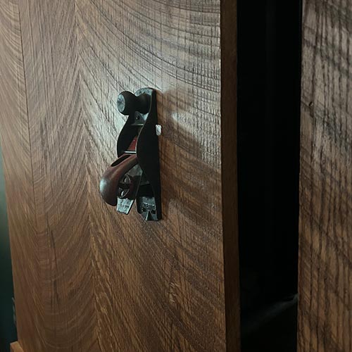 image of wooden barn style door with a plainer as a door handle